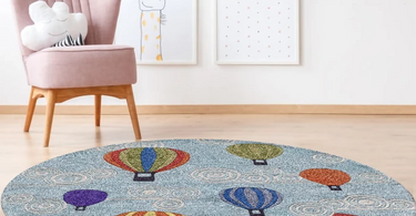 Person measuring the diameter of a round area rug in a modern living room to ensure a perfect fit under furniture
