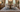 Blue and ivory square 9x9 rug under a 48-inch round dining table with four chairs