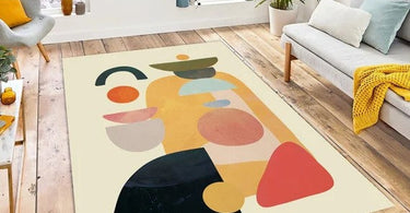 Abstract area rug in a modern living room with neutral furniture and artistic decor.