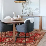 Elegant dining room featuring a large area rug under the table and chairs, enhancing the room’s warmth and style