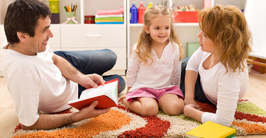 Colorful 8x10 and round washable kids rugs displayed in a bright playroom with soft toys, storage bins, and cozy seating
