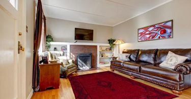 Modern living room with a large 8x10 area rug under the seating arrangement, adding warmth and structure to the space