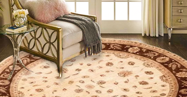 Dining area with a 48" round table centered on a perfectly sized 6' round rug in a modern, well-lit room