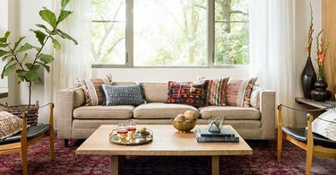 Side-by-side view of a modern geometric rug and a traditional Persian-style rug placed in two different living room settings