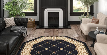 Octagon rug with ornate detailing placed under a chandelier in a classic entryway with wood flooring and neutral decor