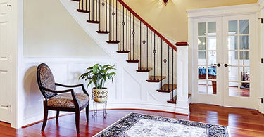 Traditional Persian rug in a cozy living room with antique furniture and warm lighting