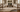Area rug corner lifted to show a felt rug pad on hardwood floor
