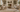 Living room rug corner rolled back showing felt and rubber rug pad on hardwood floor