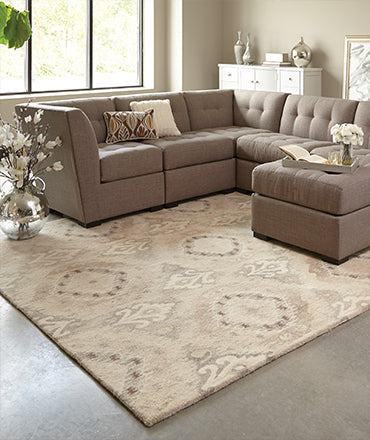 Elegant viscose area rug with a subtle sheen placed in a sophisticated living room with neutral furniture and gold accents