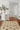 Striped indoor outdoor rug under rattan chairs on balcony