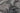Black Polypropylene area rug 5'3" X 7 - styled in a bedroom