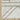 Oriental Weavers Cambria Grey 5569B Gray and Beige Oversized Dining Room Rug Geometric Area Rug 7'10" x 10'10" β folded corner showing the backing