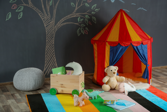 Colorful round kids rug in a bright playroom with toys and a reading nook, designed for easy cleaning and comfort