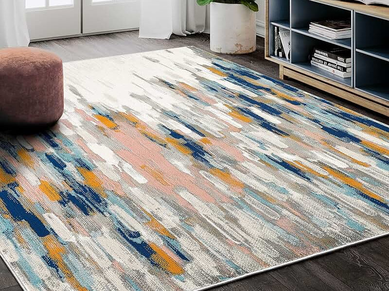 Modern living room featuring 8x10 abstract rug in vibrant colors and minimal furniture layout