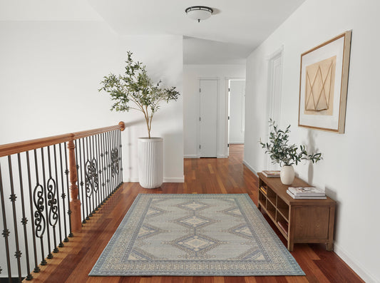 Modern living room with a neutral 9x9 square area rug placed under a sectional sofa and coffee table