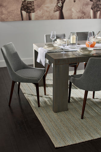Elegant dining room featuring a stylish area rug that enhances warmth and charm.