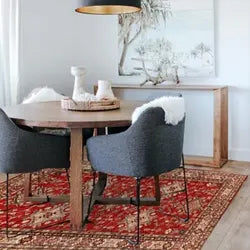Elegant dining room featuring a large area rug under the table and chairs, enhancing the room’s warmth and style