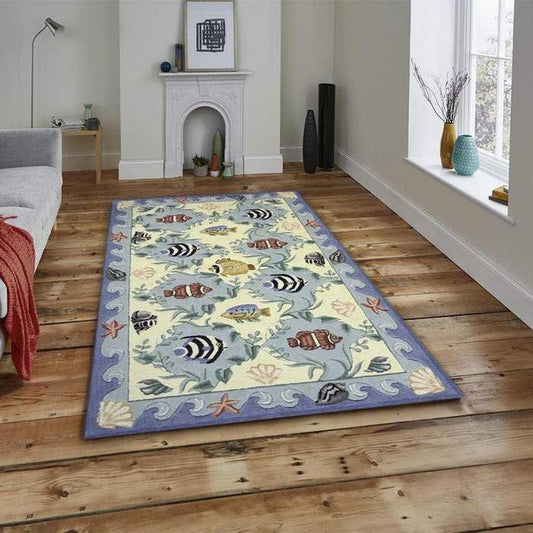 Light-toned 6x9 coastal area rug with woven texture placed in a sunlit living room with rattan chairs and ocean-themed decor