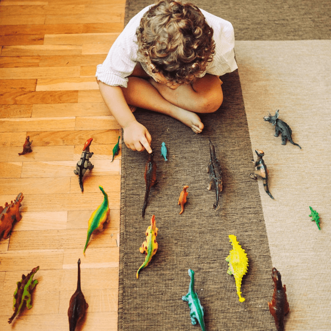 Colorful kids rectangular rug in a playful bedroom setup with toys, bookshelf, and cozy decor