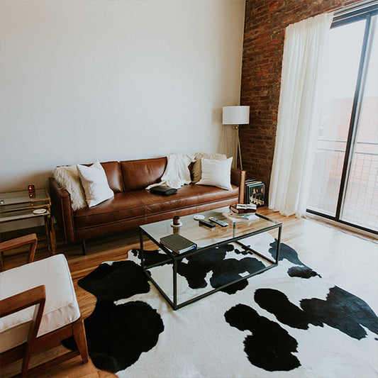 Southwestern area rug with tribal patterns in warm earth tones placed in a rustic living room