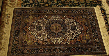 Traditional rug with floral medallion design placed under a living room coffee table and sofa, adding warmth and vintage charm