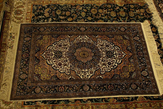 Traditional rug with floral medallion design placed under a living room coffee table and sofa, adding warmth and vintage charm