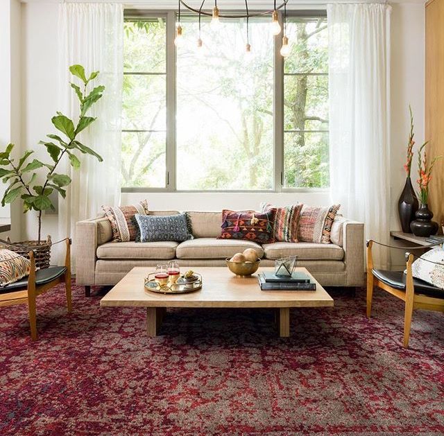 Side-by-side view of a modern geometric rug and a traditional Persian-style rug placed in two different living room settings
