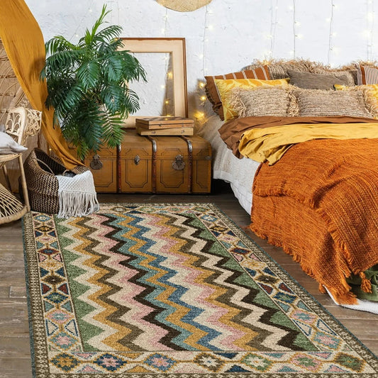 Bedroom with an 8x10 area rug under a queen bed, styled with neutral bedding and soft lighting