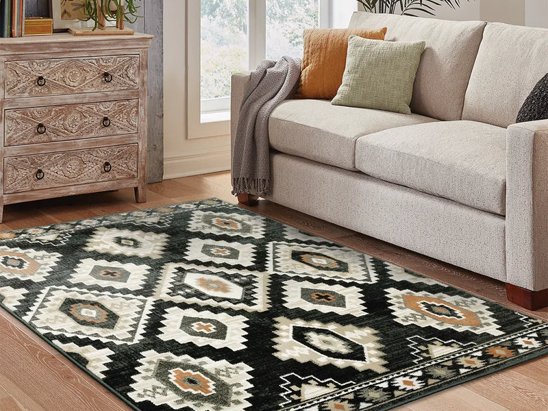 Neutral farmhouse area rug placed in a rustic living room with a wooden coffee table, linen sofa, and vintage farmhouse decor