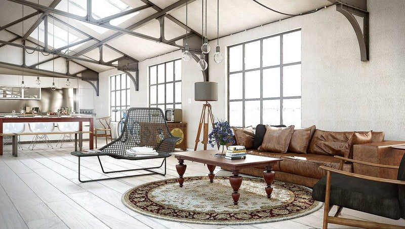 Dining room with a round table centered on an oval rug, showing how rug shape complements furniture and space