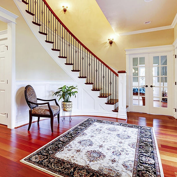 Traditional Persian rug in a cozy living room with antique furniture and warm lighting