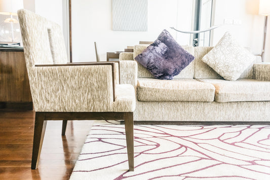 Modern abstract area rug with vibrant brushstroke patterns in a stylish living room