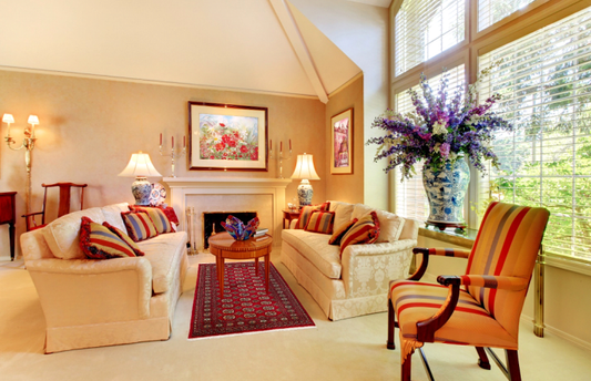 Side-by-side view of a modern geometric rug and a traditional Persian-style rug placed in two different living room settings