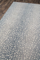 Safari-style antelope rug in rich blue tones styled in bedroom