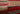 Red Geometric area rug 6' X 9' - styled in a bedroom