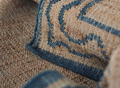 Slate, natural, and brown ripple-patterned rug in handwoven jute and wool