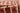 Red Wool area rug 2'6" X 8 - styled in a bedroom