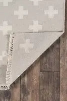 Durable wool geometric rug laid out on clean white flooring