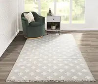 Geometric patterned rug with soft neutral tones in a family room