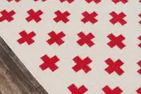 Close-up detail of geometric patterns on handwoven wool rug
