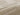 Beige Polypropylene area rug 5'3" X 7 - styled in a bedroom
