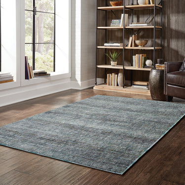 Oriental Weavers Atlas 8033J Blue and Gray Large Seating Area Rug Polypropylene Blend Area Rug 6'7" x 9'6" — styled in a furnished room