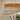 Oriental Weavers Bauer Orange 090R2 Rust and Gold Medium Living Room Rug Geometric Area Rug 5'3" x 7'6" — corner turned to show the edge