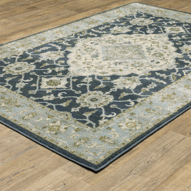 Oriental Weavers Branson BR05A Teal Blue and Ivory Medium Living Room Rug Polypropylene Area Rug 5'3" x 7'3" — angled view showing pattern scale