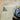 Oriental Weavers Branson BR10A Blue and Green Medium Living Room Rug Modern Area Rug 5'3" x 7'3" — corner turned to show the edge